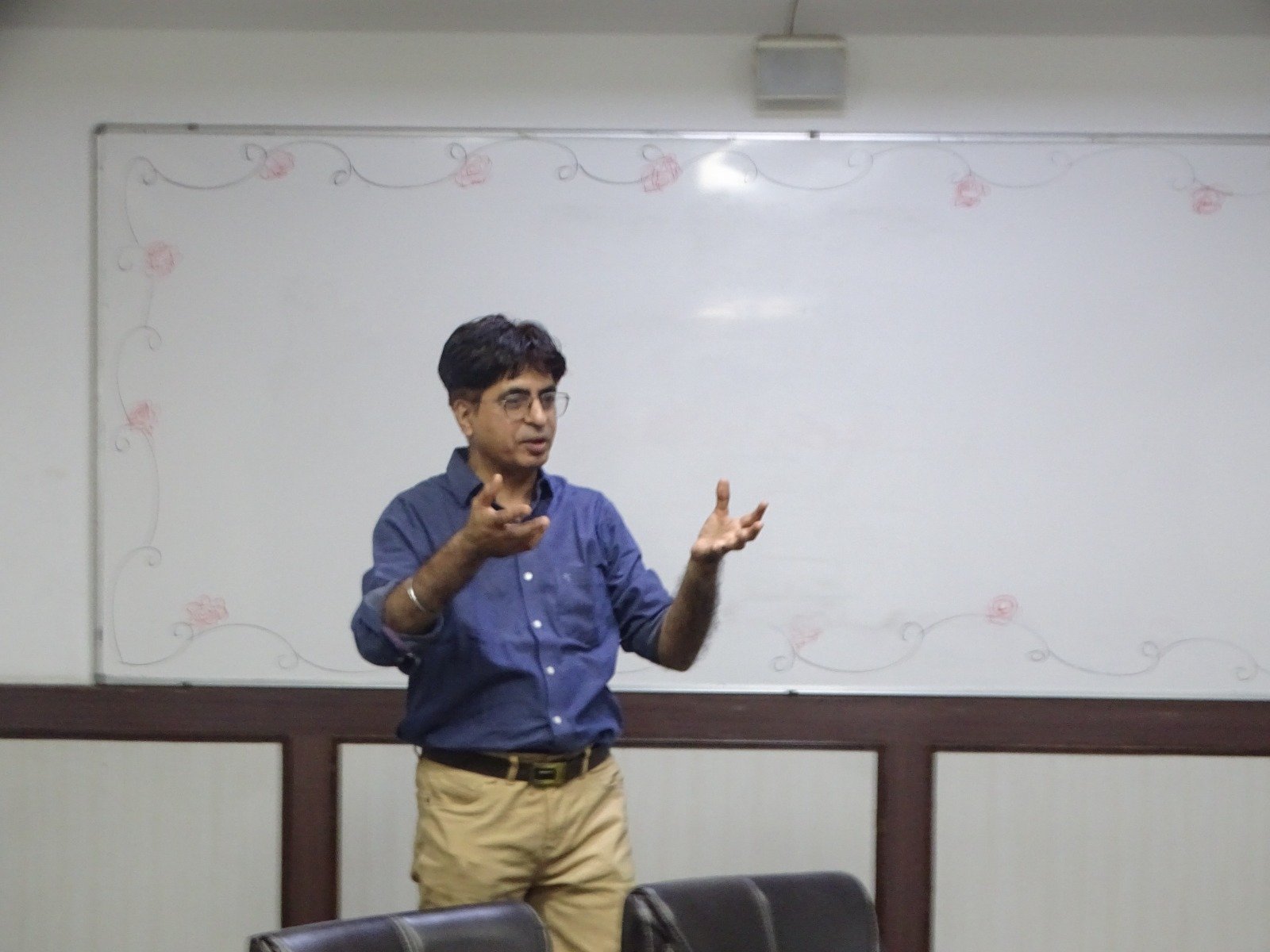 Rajeev Vashista standing and delivering a training session